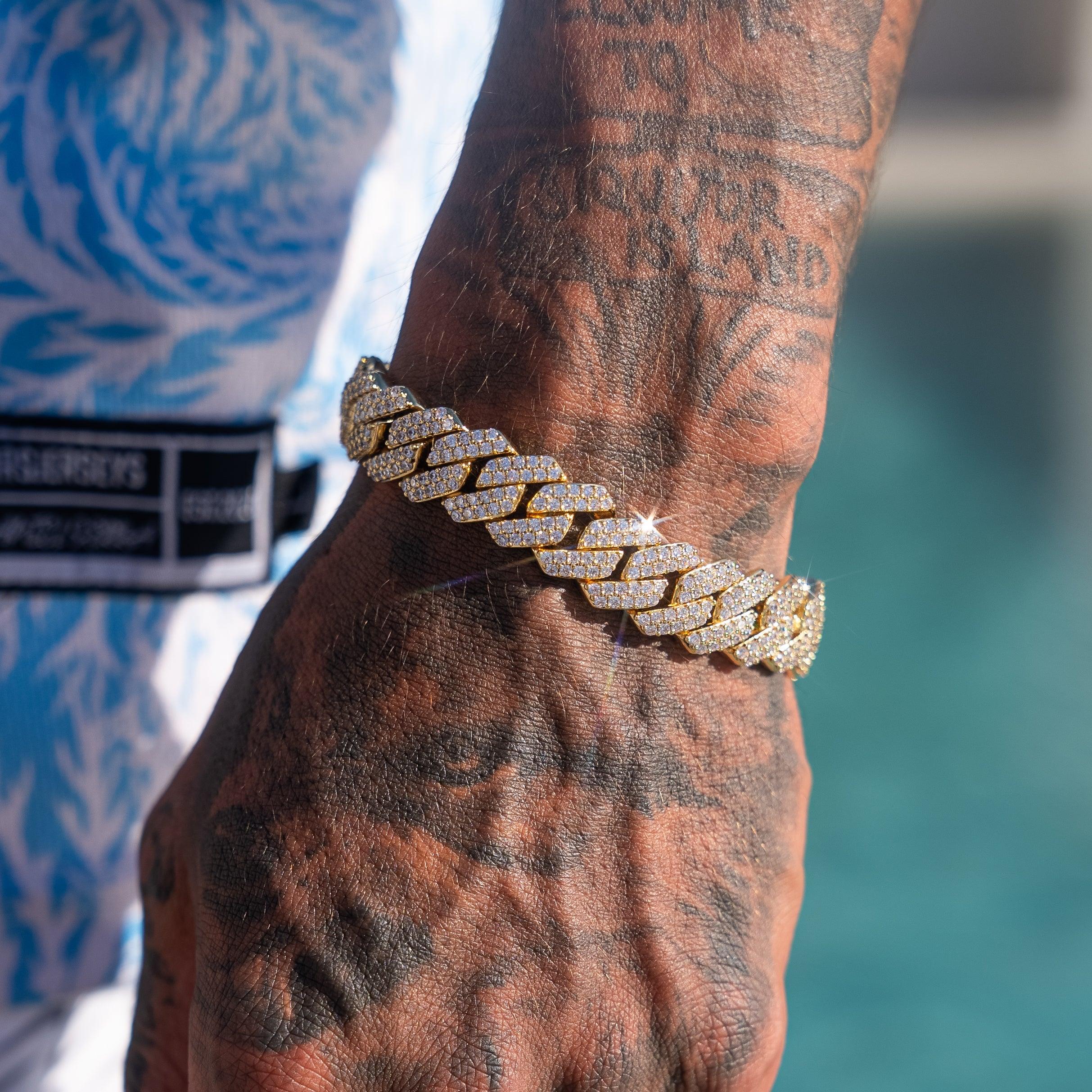 14mm Monaco Bracelet in gold with prong-lifted stones, worn on tattooed wrist.