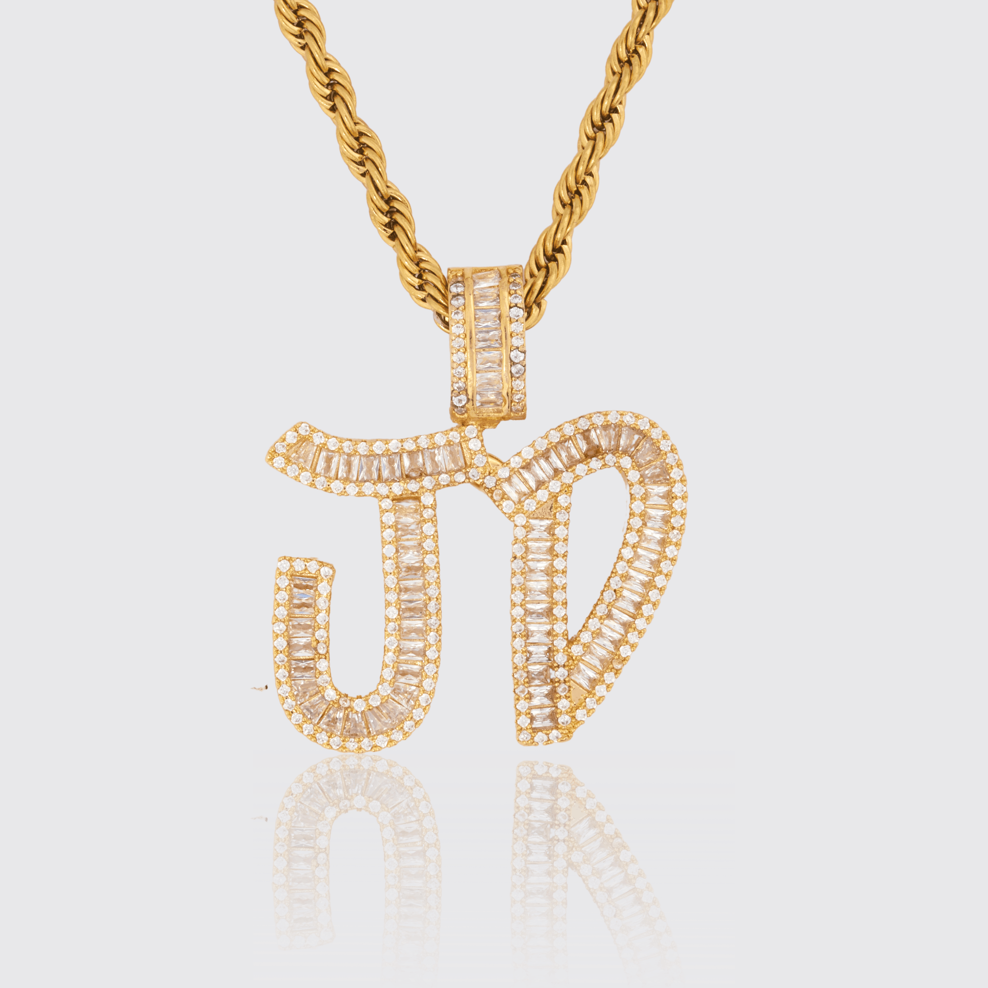 Custom Brush Font Pendant with diamond simulants on gold rope chain.