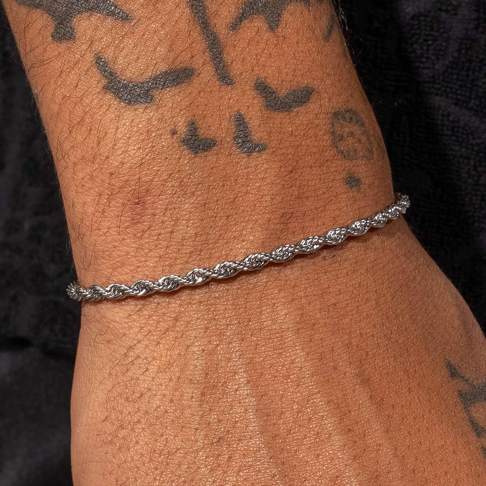 2.5mm white gold rope bracelet on wrist, 18K plated.