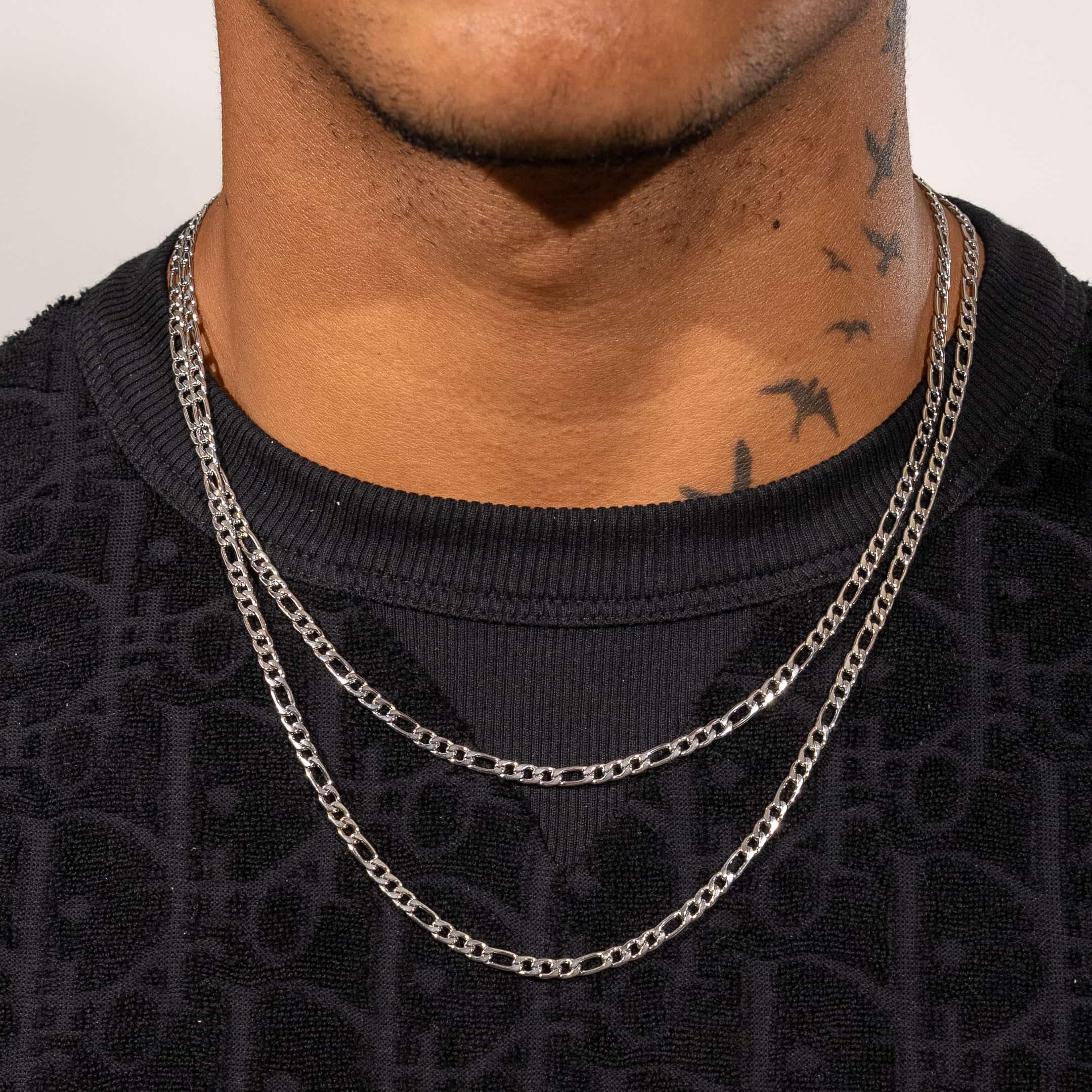 4mm Figaro chain in white gold on a person, featuring 18K PVD vacuum plating over stainless steel.